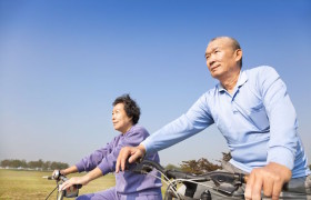 Older couple riding bicycles together