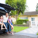 Couple in front of their new house